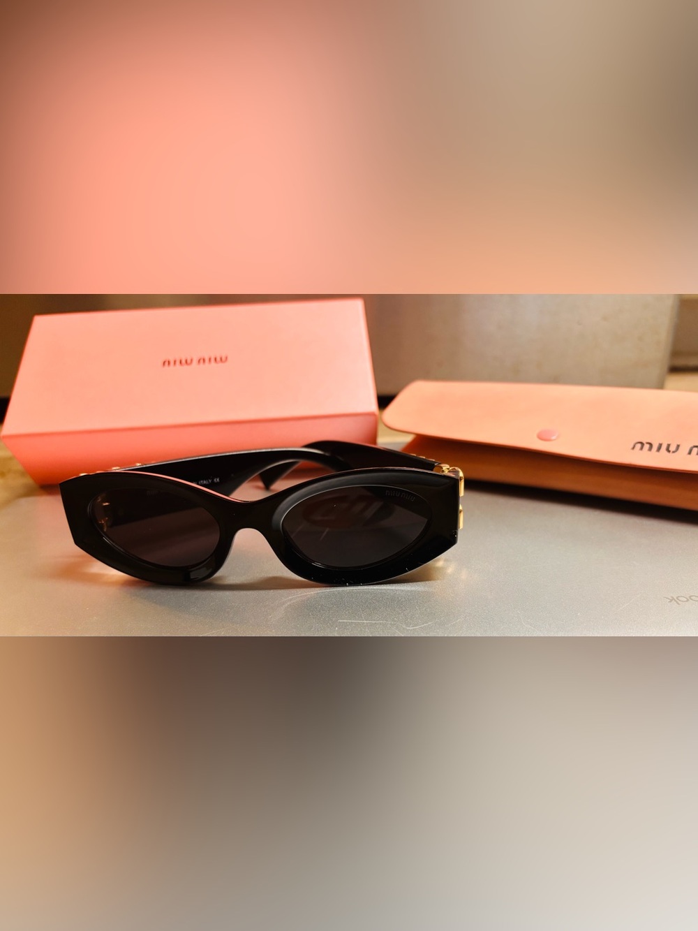Miu Miu Black Oval Sunglasses with Dark Lenses